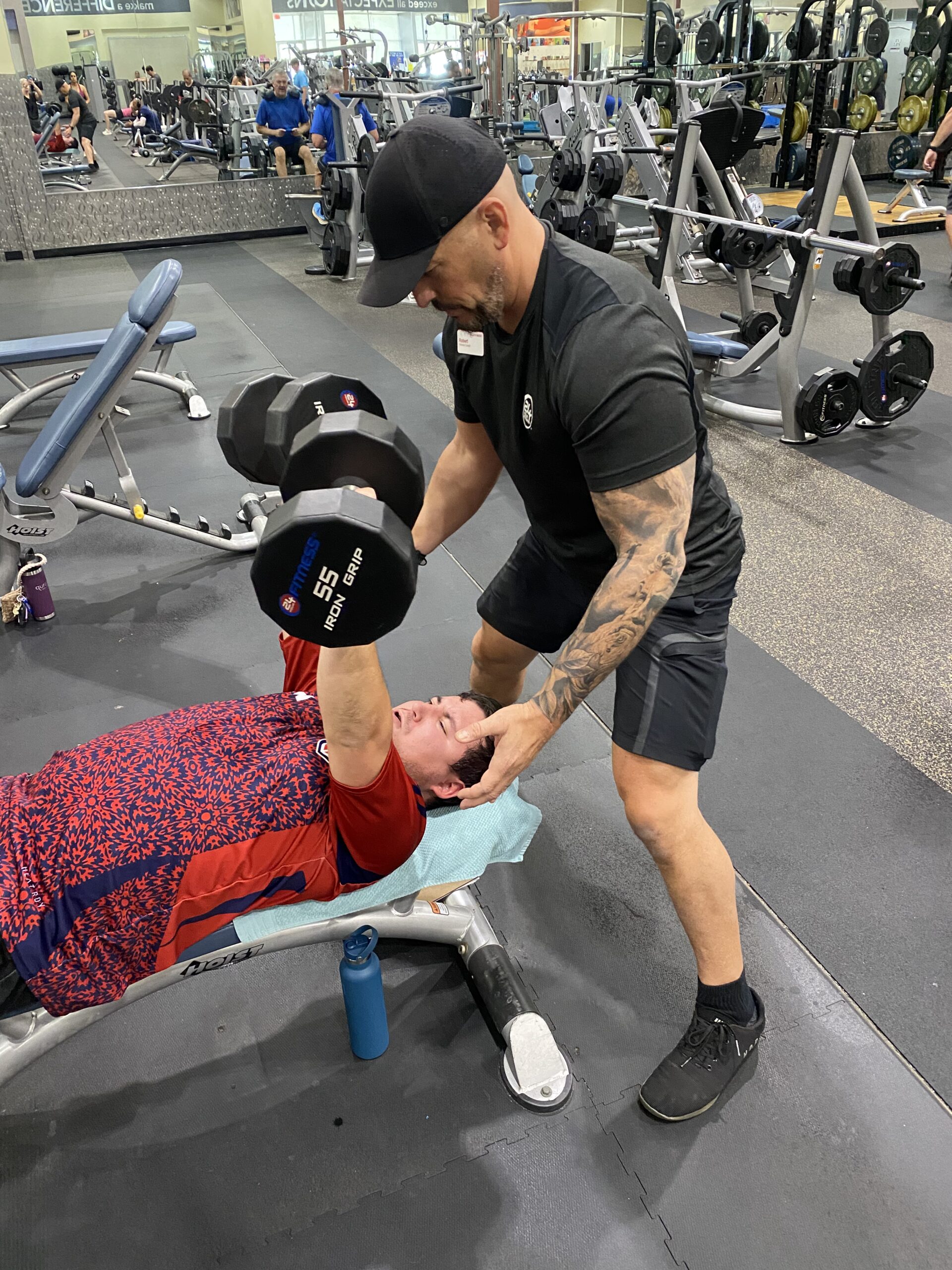 Coach spotting a client during a 1:1 personal training session