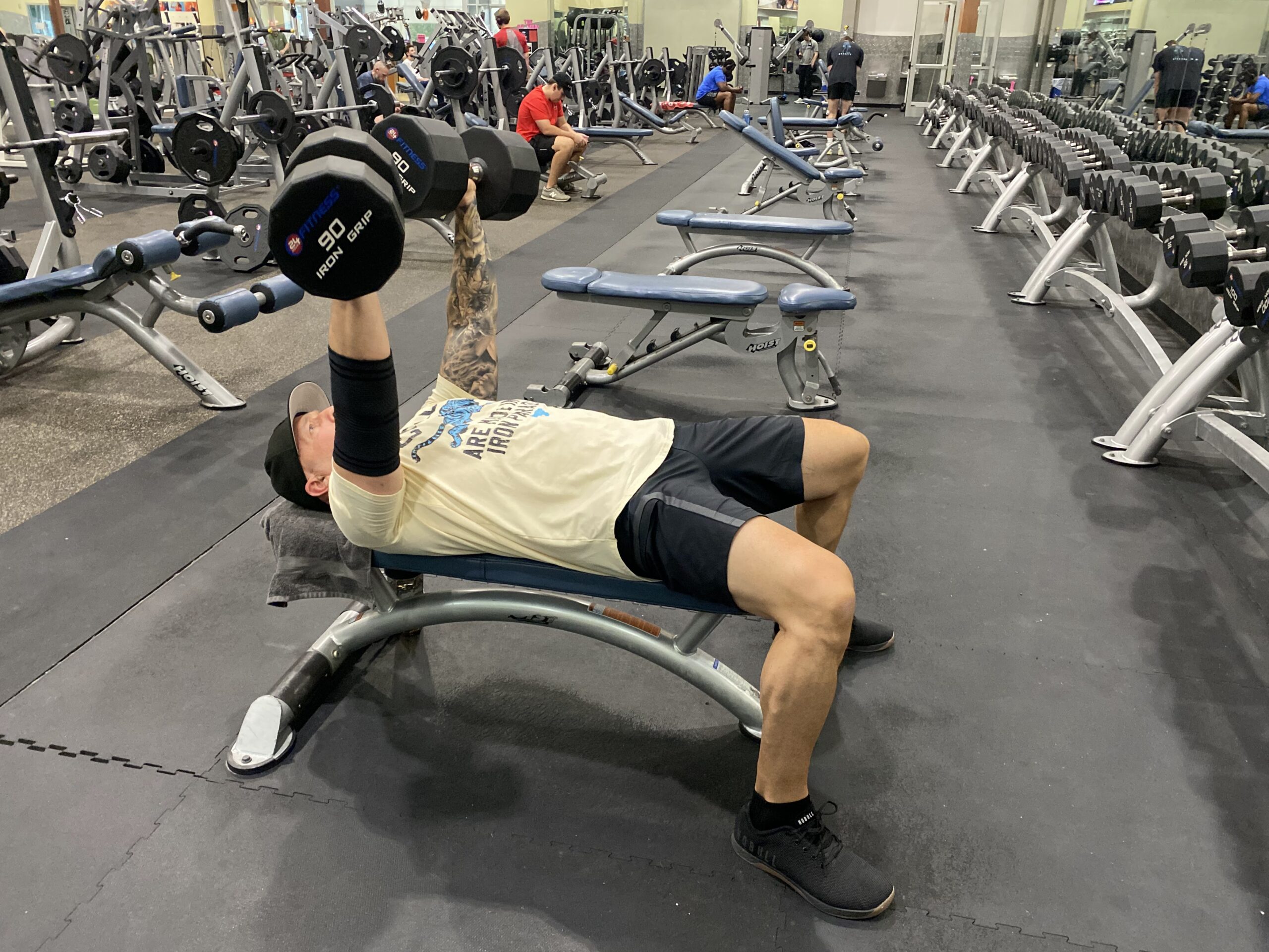 Client performing a dumbbell bench press